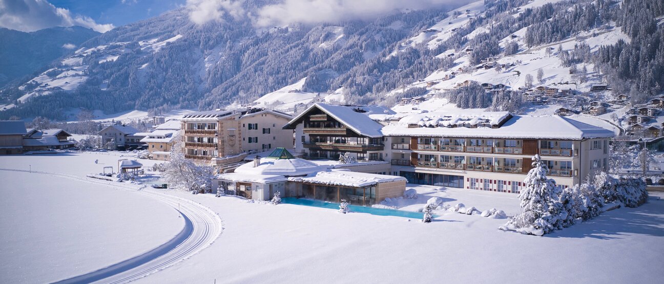 Exterior view of Hotel Theresa in the Zillertal in winter with a cross-country ski trail