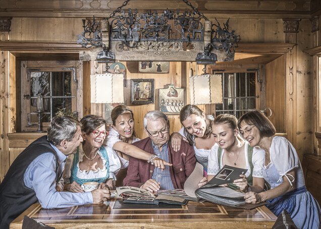 The Egger family is sitting at a regular's table in the Zillertal at Hotel Theresa Zillertal