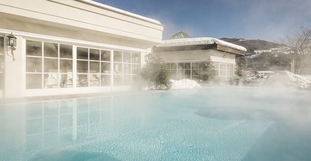 Heated pools stand in front of Hotel Theresa Zillertal in winter