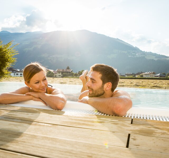 A couple relaxes in the saltwater pool at the Hotel Theresa