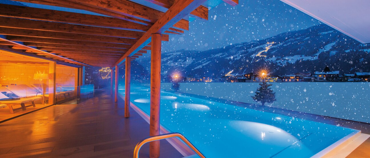 Snowflakes fall on the 25-meter pool at the Zillertal Hotel Theresa