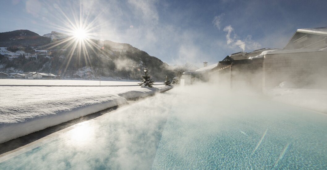Winter sun shines on the sports pool of Hotel Theresa in Zillertal