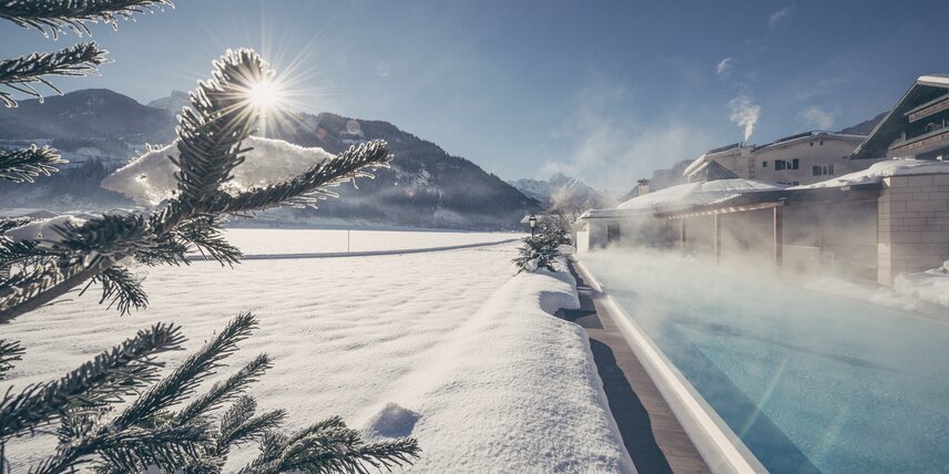 Snow lies next to the sports pool at the Zillertal Hotel Theresa
