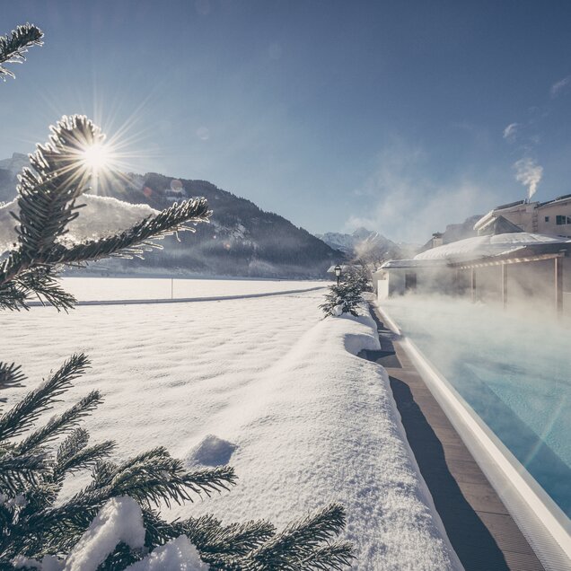 Snow lies next to the sports pool at the Zillertal Hotel Theresa
