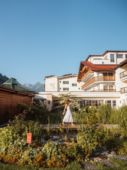 A bridge in the garden of Hotel Theresa Zillertal in the morning atmosphere is pictured