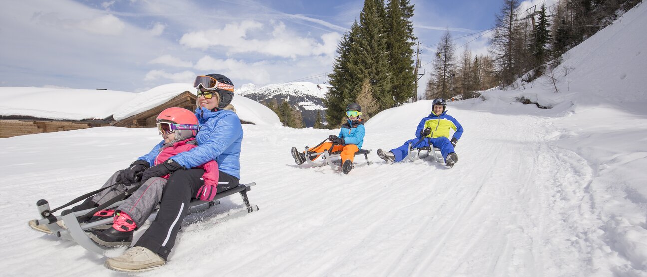 A family sleds down the toboggan run on the Gerlosstein in the Zillertal Arena