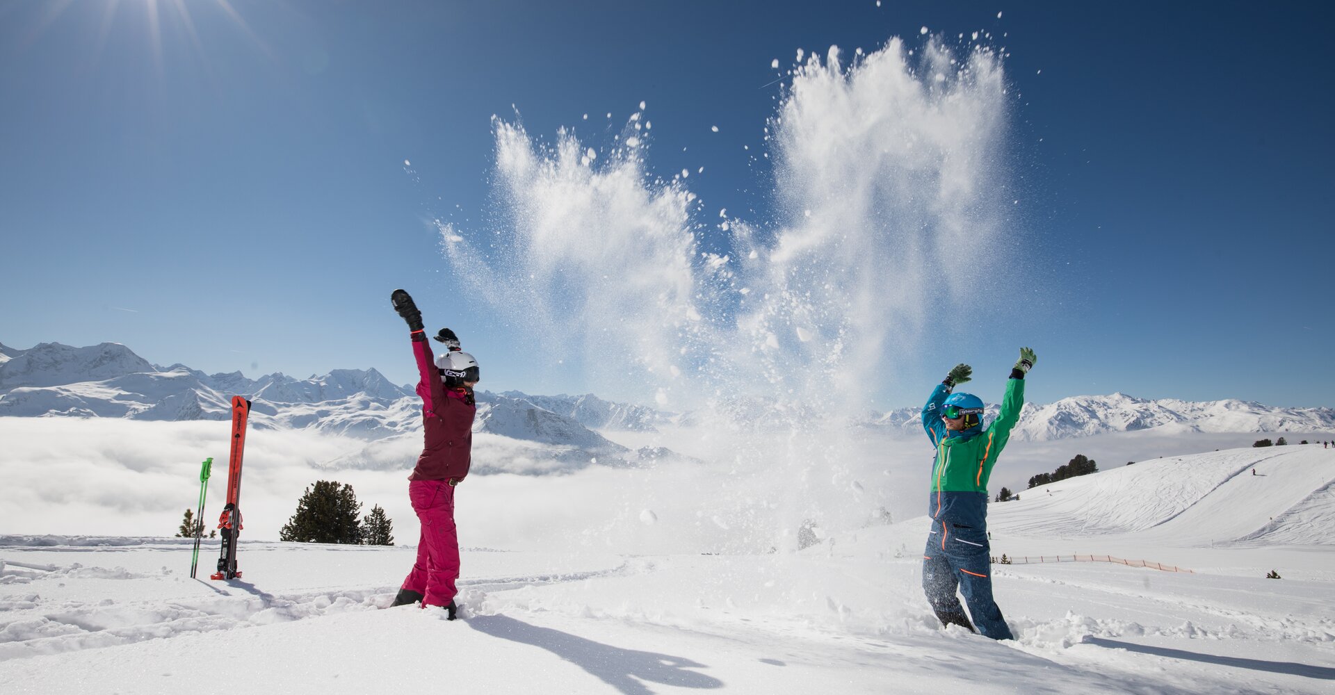 Im strahlenden Sonnenschein toben Kinder im Winter in der Zillertal Arena im Schnee