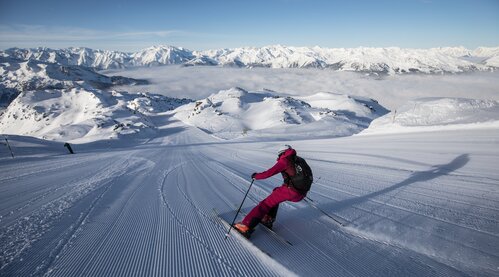 A skier skis in the Zillertal Arena ski area near the Wilde Krimml