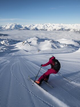 A skier skis in the Zillertal Arena ski area near the Wilde Krimml